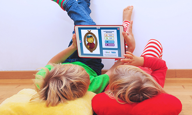 Two kids reading with Skybrary on a tablet