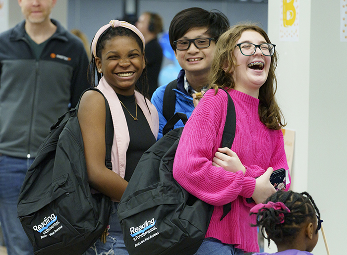 Three kids laughing with RIF backpacks on