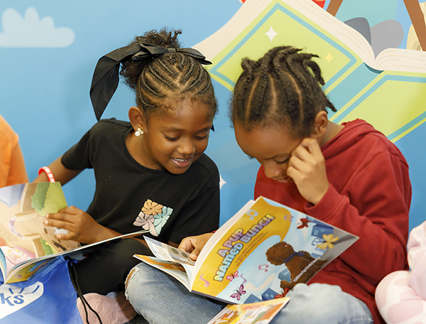 Boy and girl reading books together