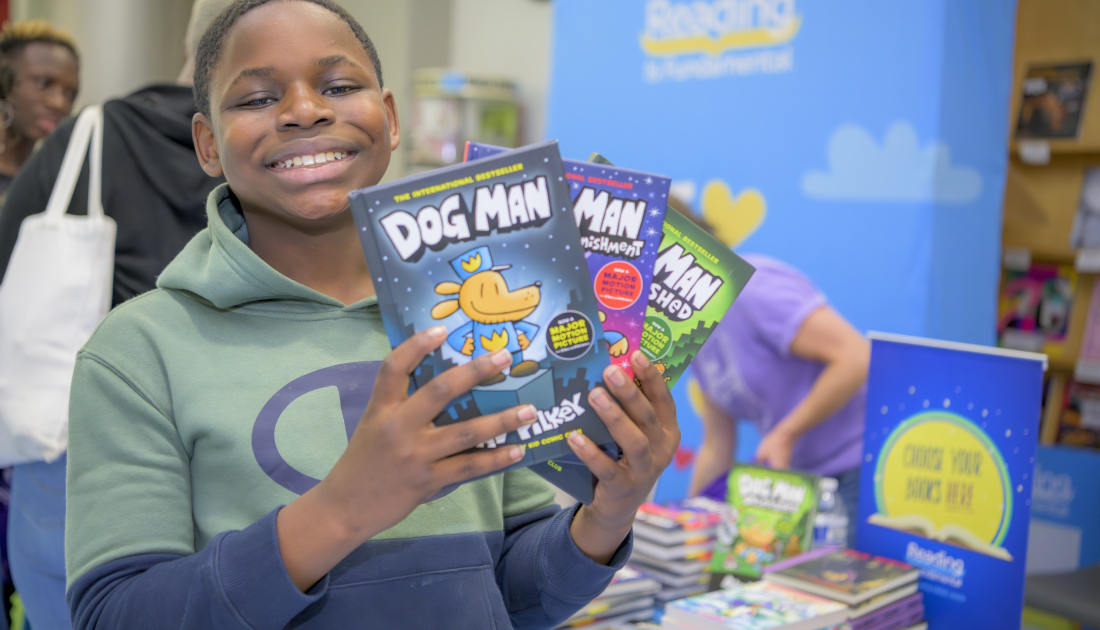 boy smiling with books