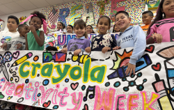 Crayola Creativity Week Banner held by smiling kids