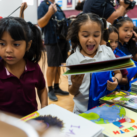 Girls excited joy on faces Amazon RIF book event