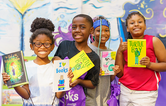 Happy kids posing with books