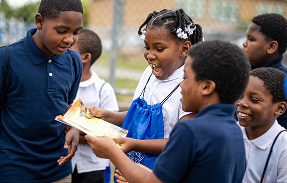 Kids looking at a book together