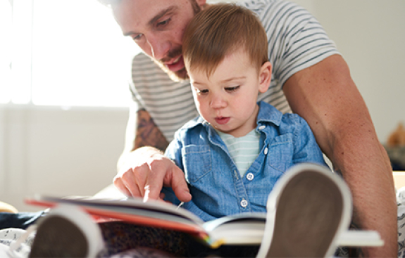 Photo of dad and child reading