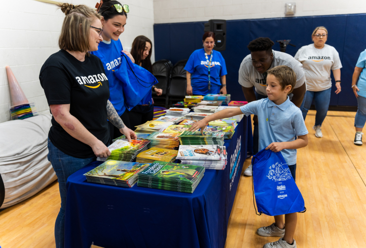 Volunteers at book distribution table RIF reading event