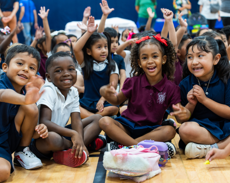 Group of young children smiling at book event