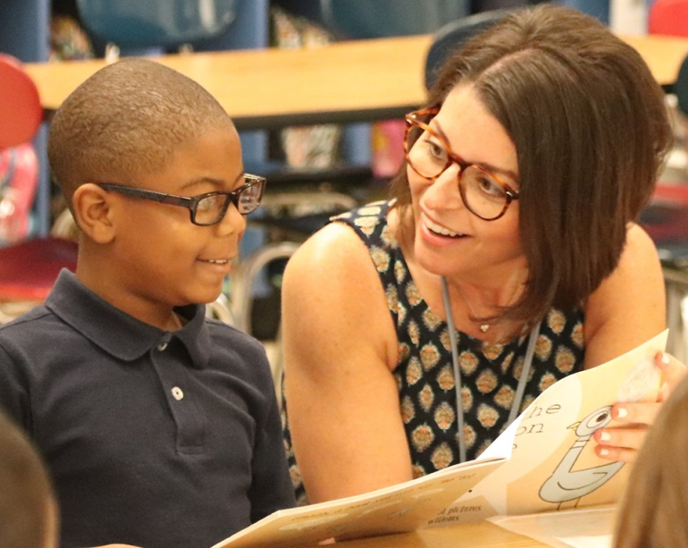 RIF Volunteer reading with a child making a difference