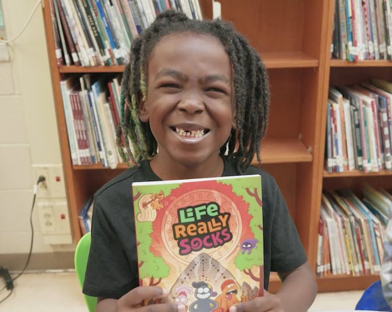 Smiling boy with book