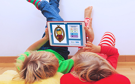 Two kids reading with Skybrary on a tablet